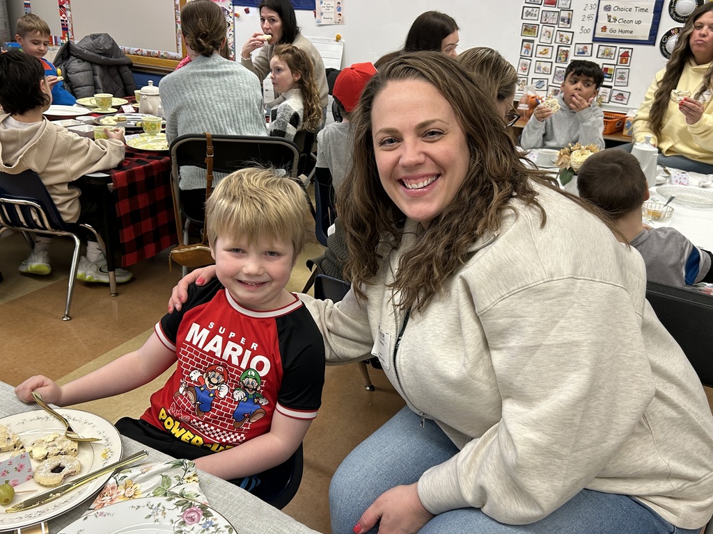 kindergarten student with their special guest at a tea party