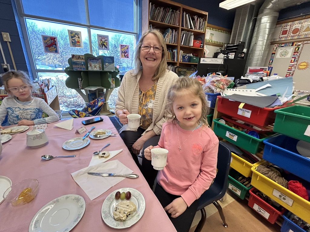 kindergarten student with their special guest at a tea party