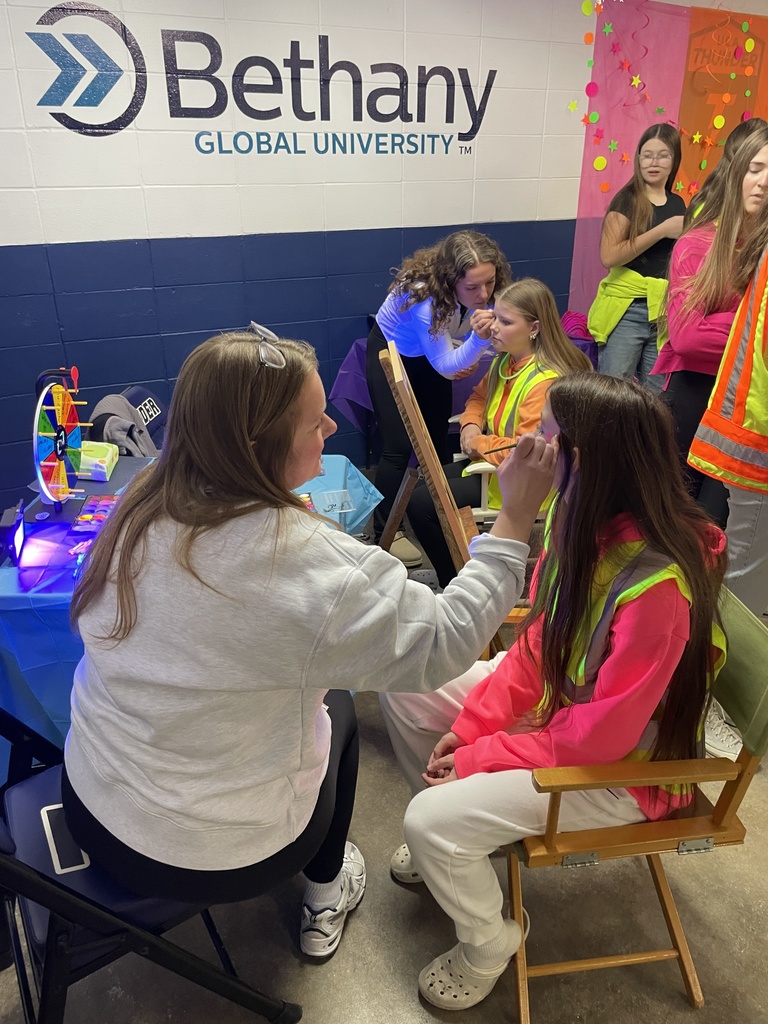 high school girls having their faces painted