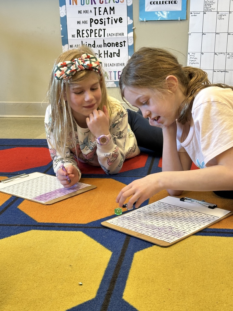 2nd grade girls playing a counting game with dice