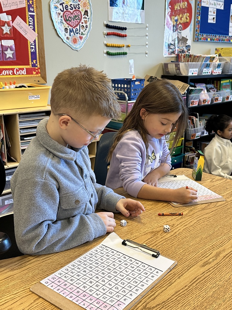 2nd grade students playing a counting game with dice