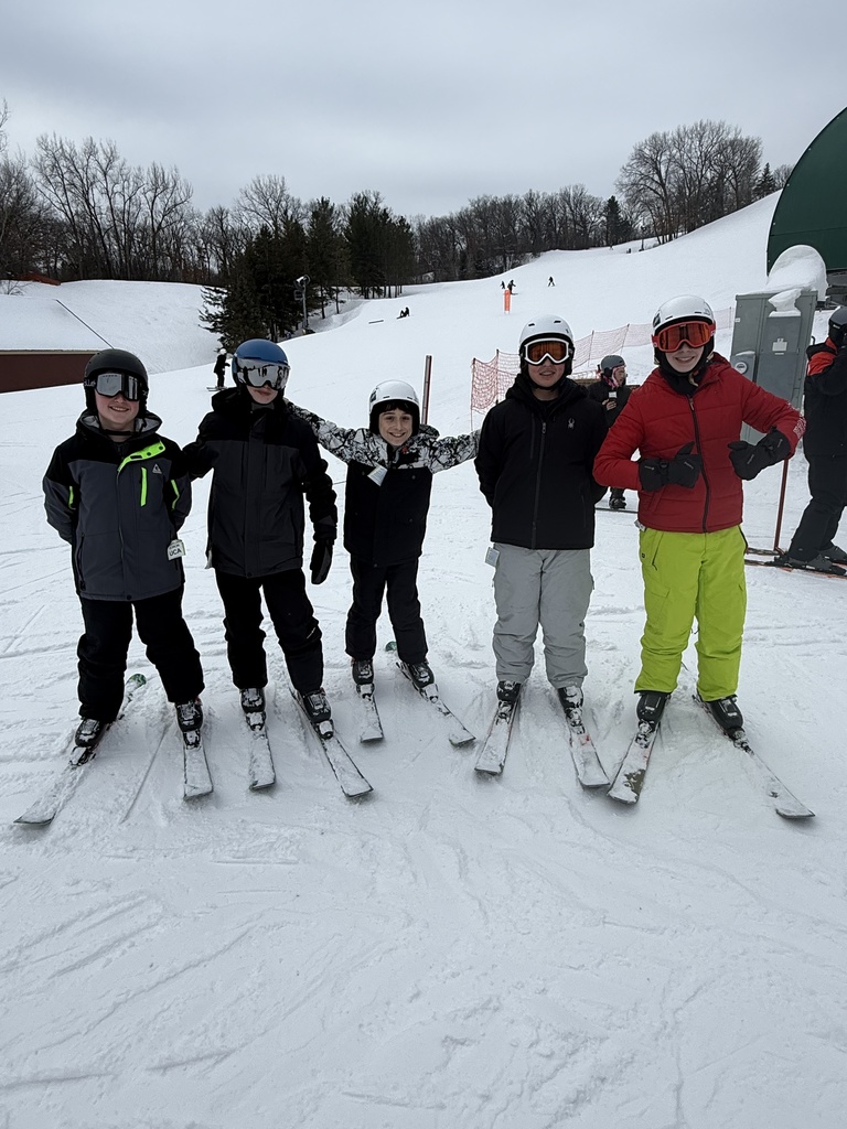 group of middle school students on a ski hill for a field trip