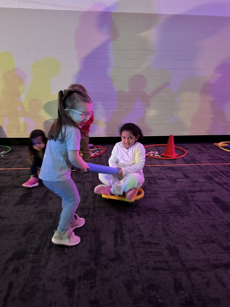 elementary students going through an obstacle course
