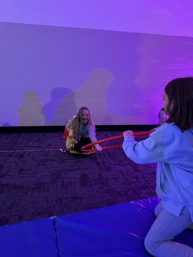elementary students going through an obstacle course