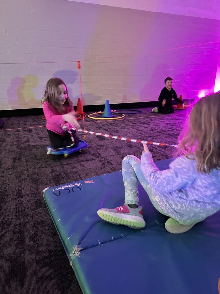 elementary students going through an obstacle course