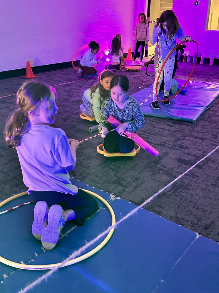 elementary students going through an obstacle course