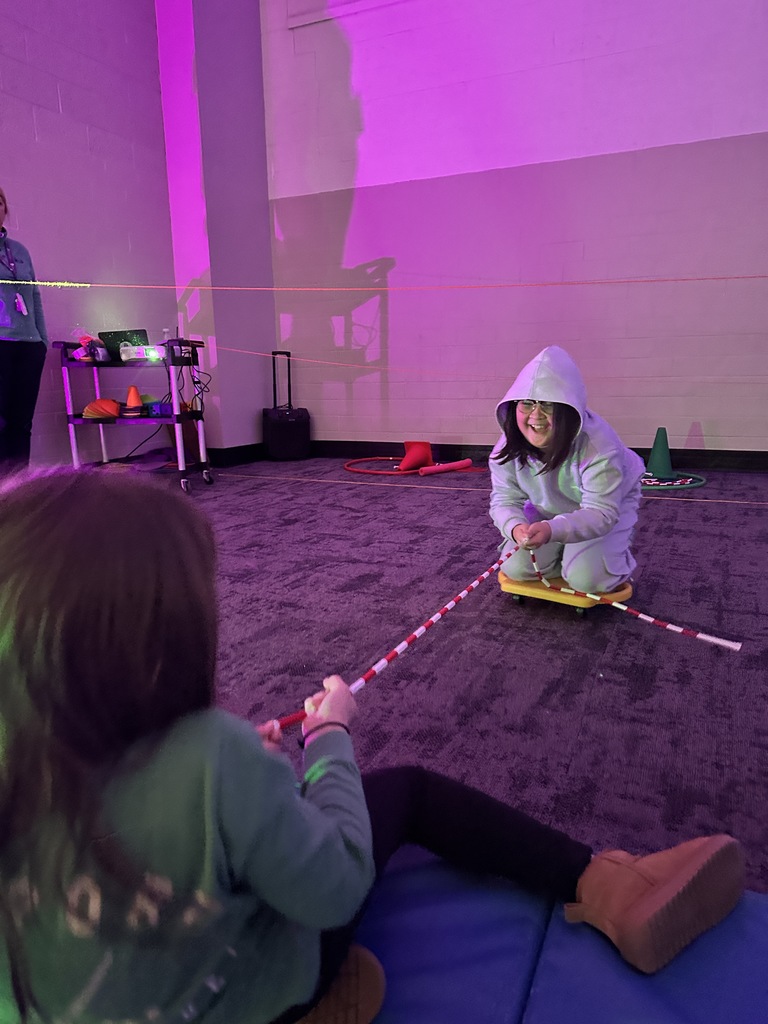 elementary students going through an obstacle course