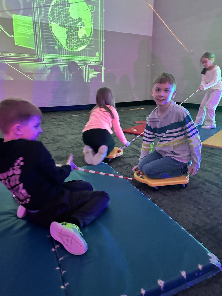 elementary students going through an obstacle course