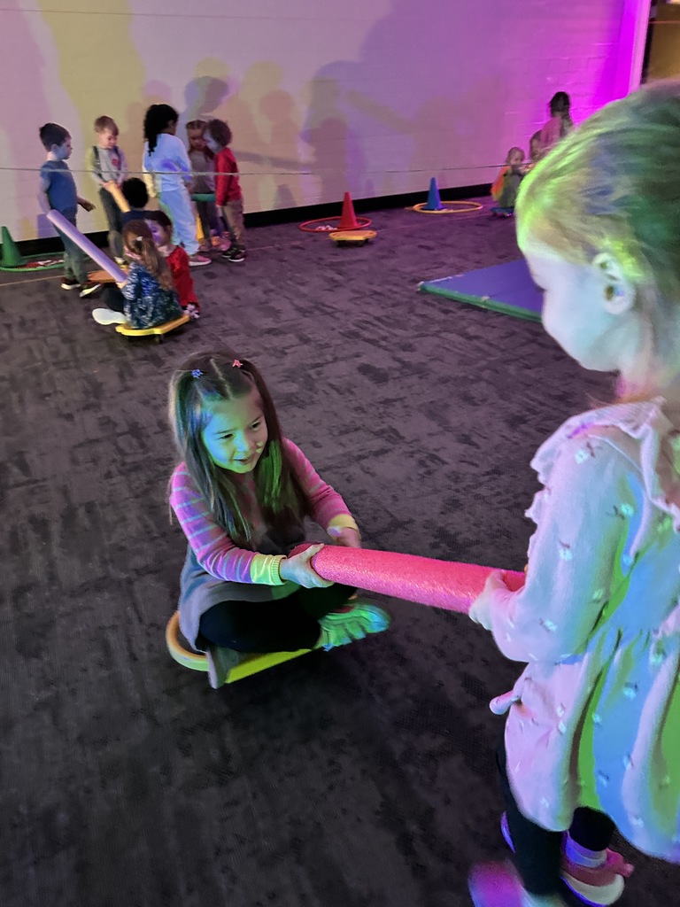 elementary students going through an obstacle course