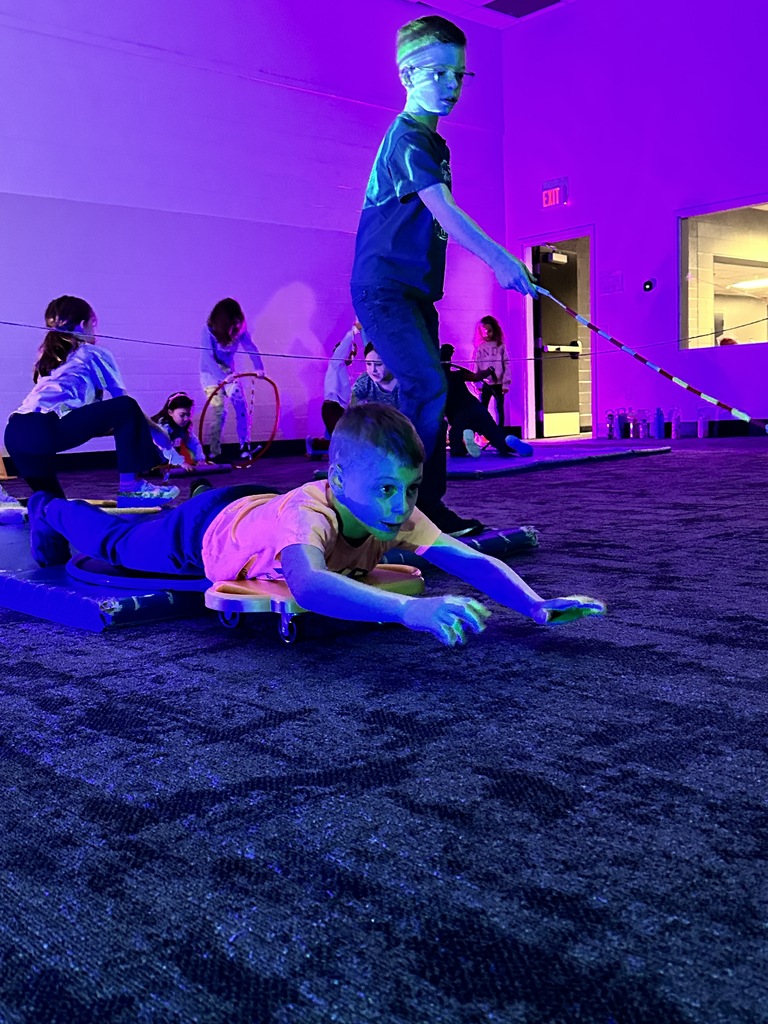 elementary students going through an obstacle course