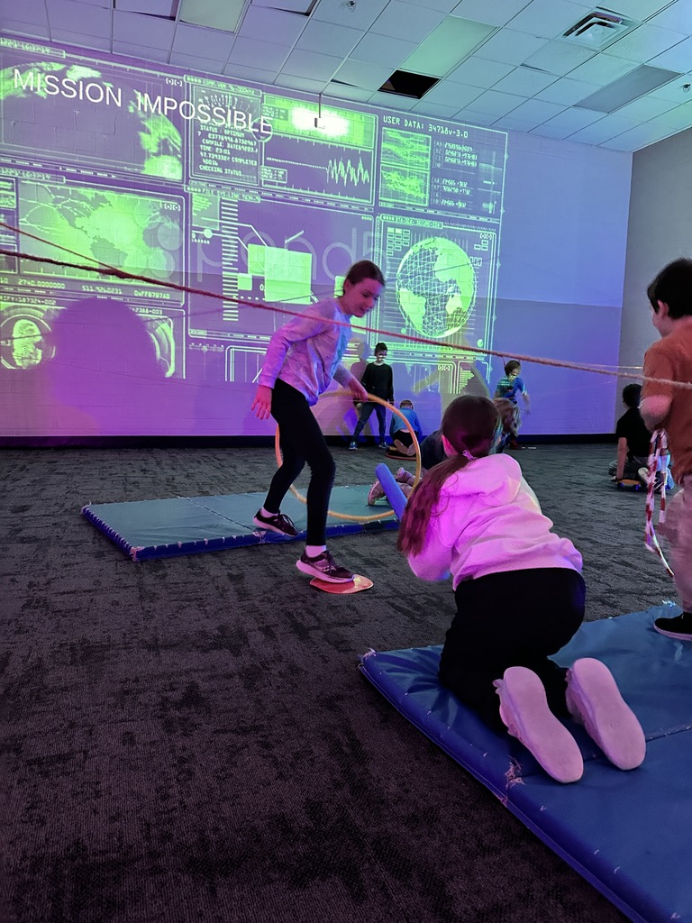 elementary students going through an obstacle course