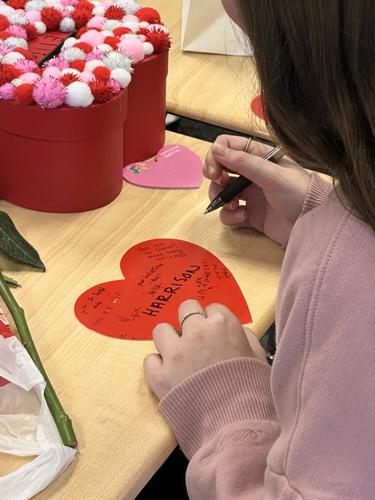 5th grade student writing a kind note to a classmate