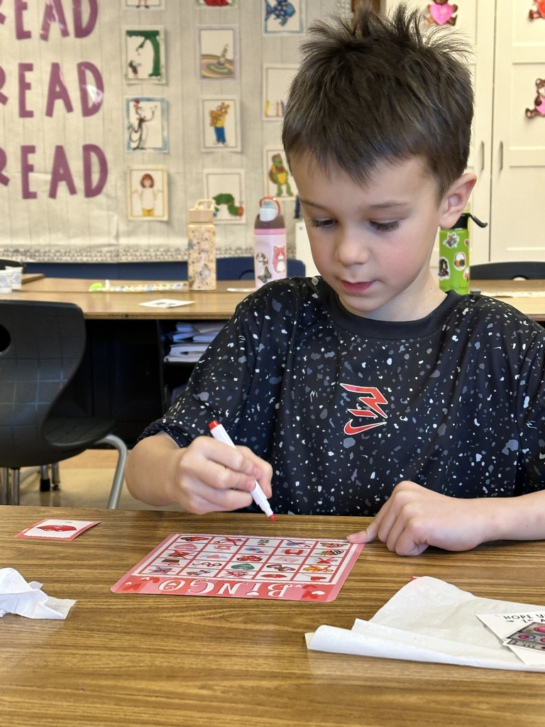 1st grade boy playing Valentine bingo
