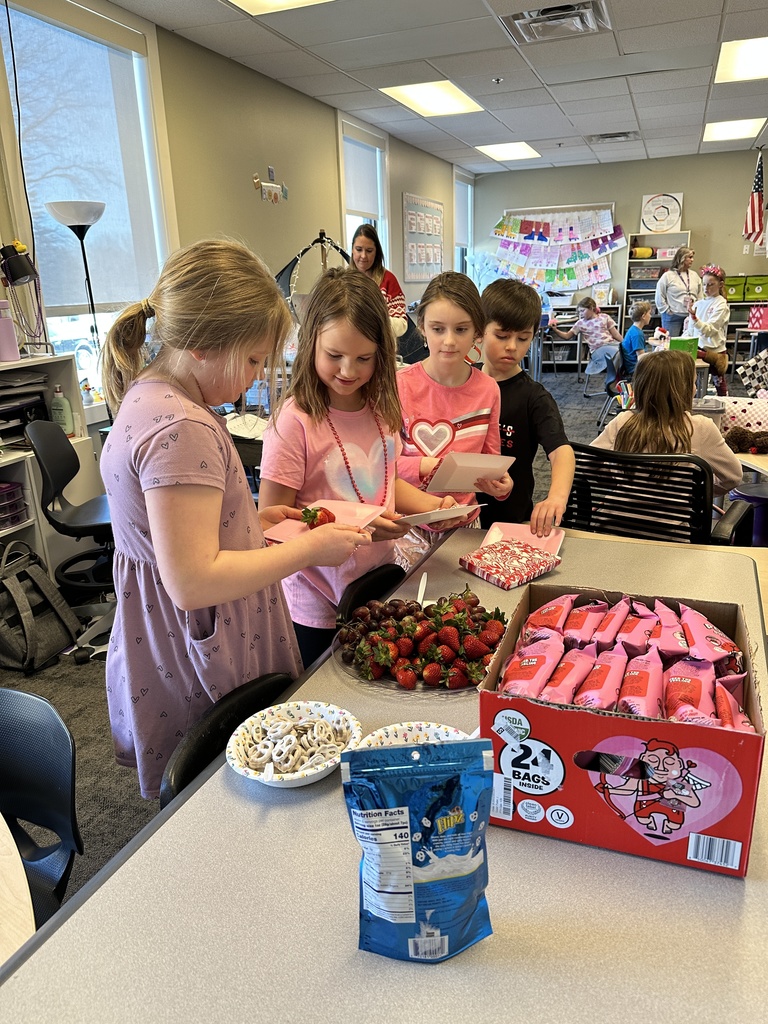3rd grade students in line to get a plate of treats