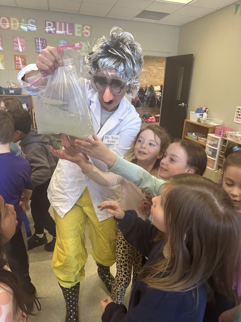 teacher dressed up as a scientist to engage kindergarten students in an experiment about magnets