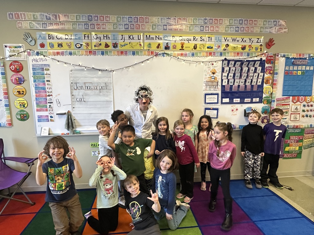 teacher dressed up as a scientist to engage kindergarten students in an experiment about magnets