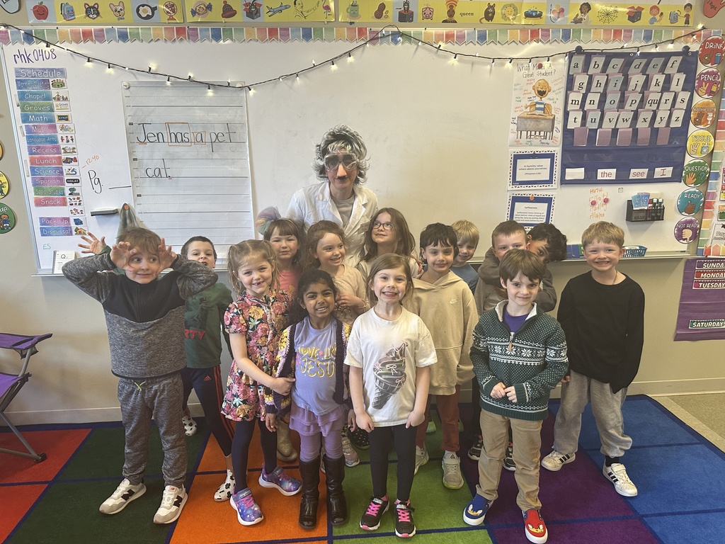 teacher dressed up as a scientist to engage kindergarten students in an experiment about magnets