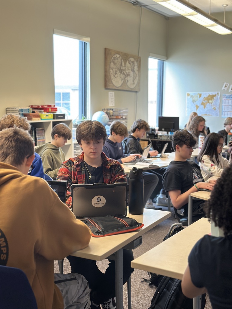 students sitting in a classroom working on their Chromebooks