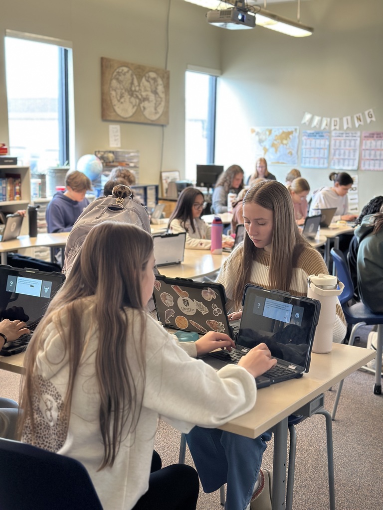 students sitting in a classroom working on their Chromebooks