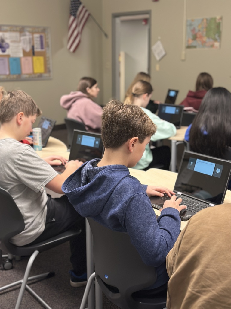 students sitting in a classroom working on their Chromebooks