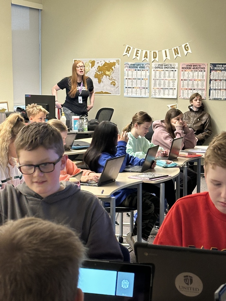 students sitting in a classroom working on their Chromebooks