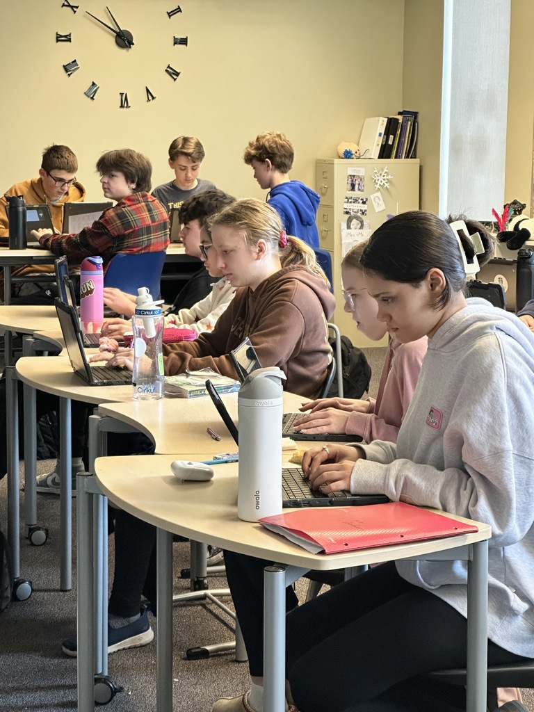 students sitting in a classroom working on their Chromebooks