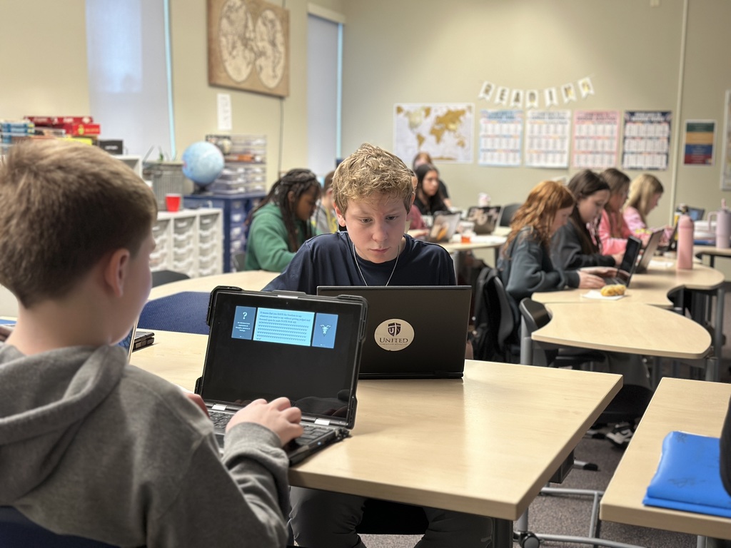 students sitting in a classroom working on their Chromebooks