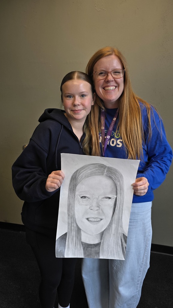 high school student standing with a high school teacher whom she drew a portrait of