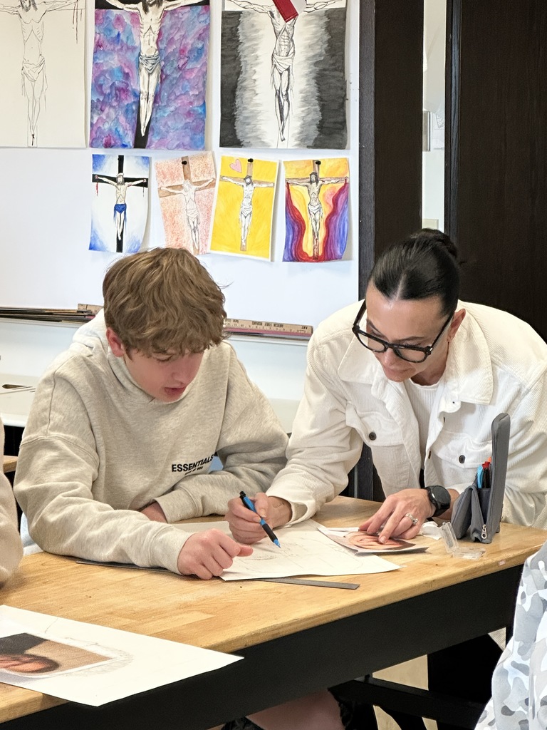 high school art students working on a portrait project