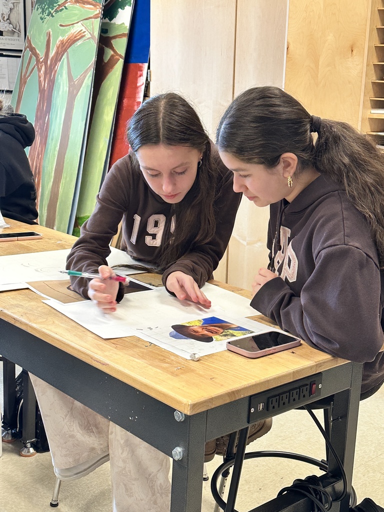 high school art students working on a portrait project