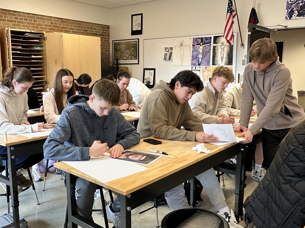 high school art students working on a portrait project
