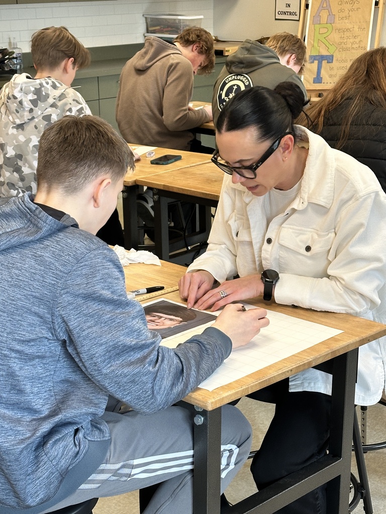 high school art students working on a portrait project