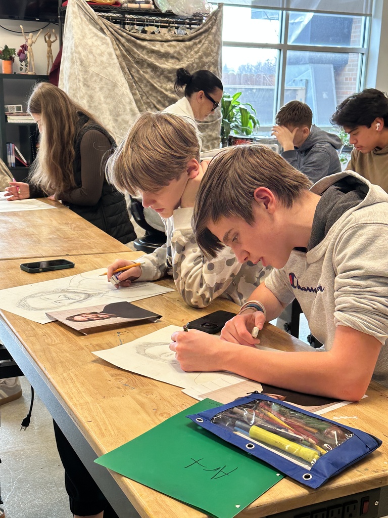 high school art students working on a portrait project