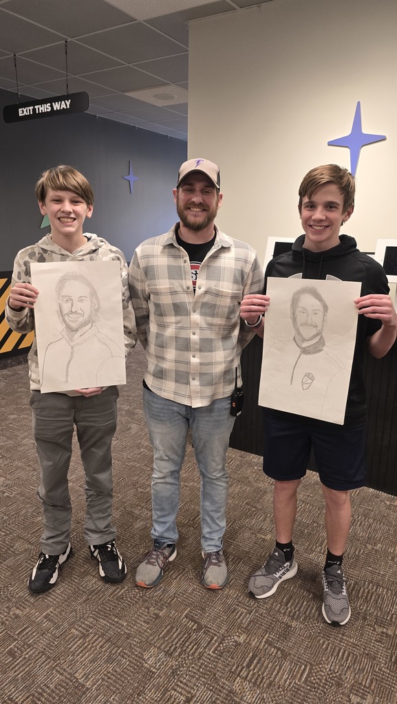 high school students standing with a high school teacher whom they drew a portrait of