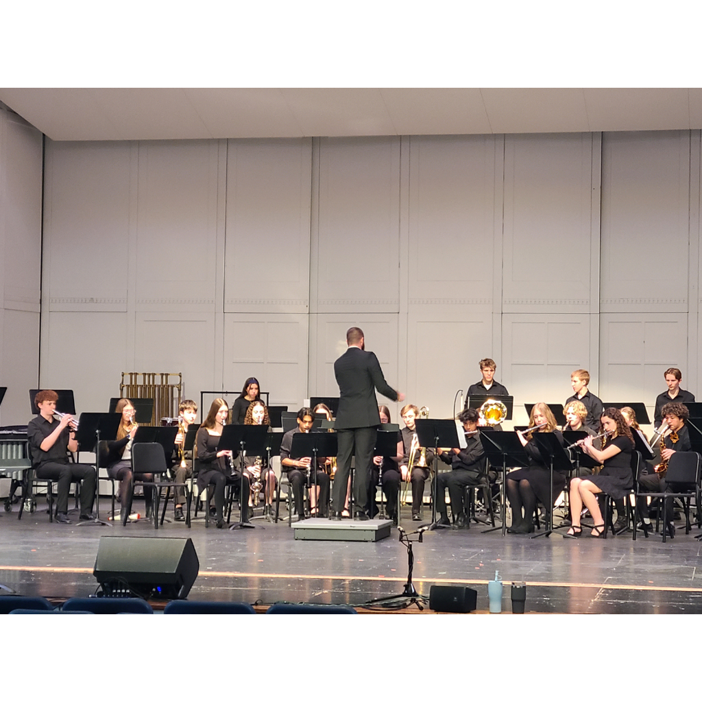 the high school band performing on stage