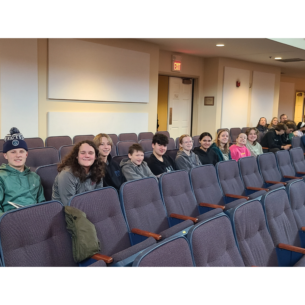 8th grade students as spectators watching the high school band perform