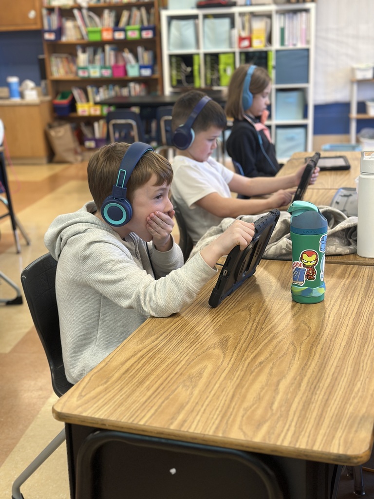 1st grade students working on their iPads