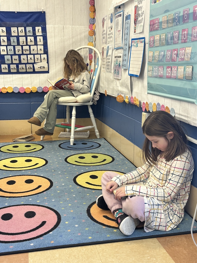 two first grade students quietly reading to themselves