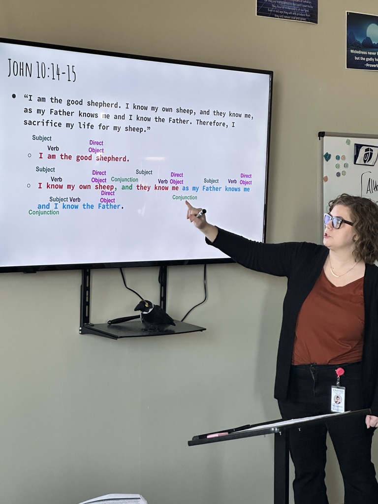 teacher pointing at the lesson on the screen