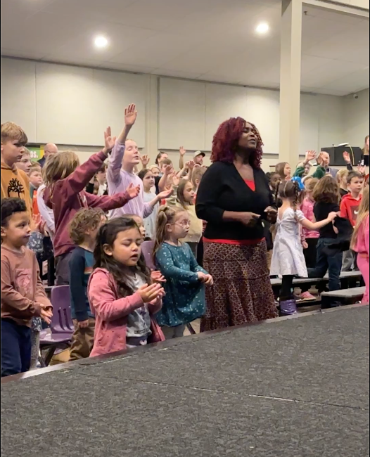 elementary students worshiping in chapel