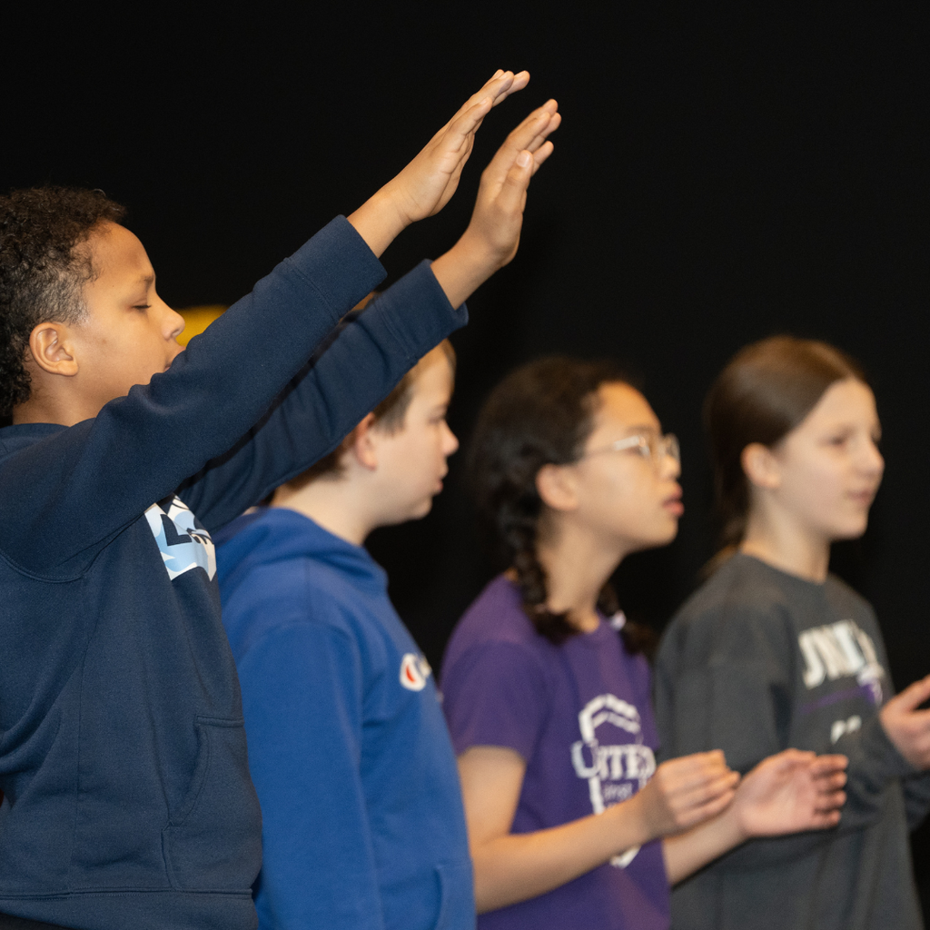 elementary students worshiping in chapel
