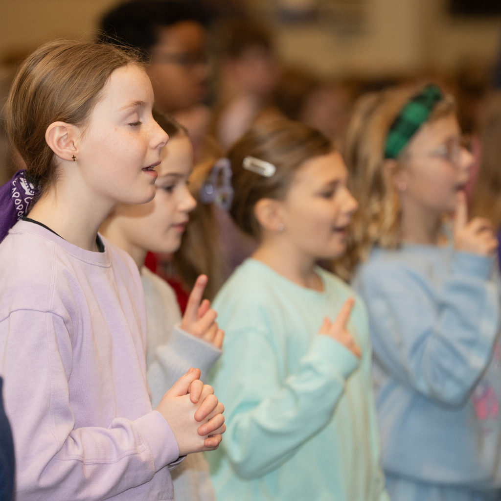 elementary students worshiping in chapel