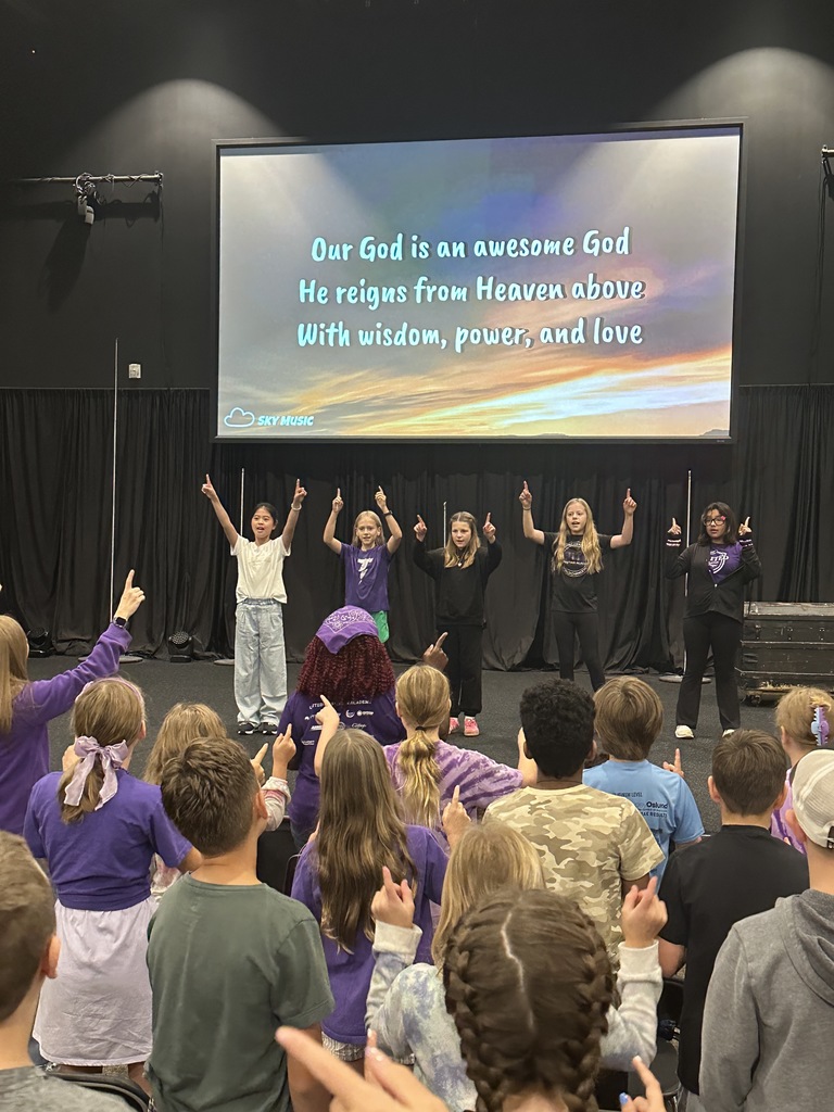 elementary students worshiping in chapel