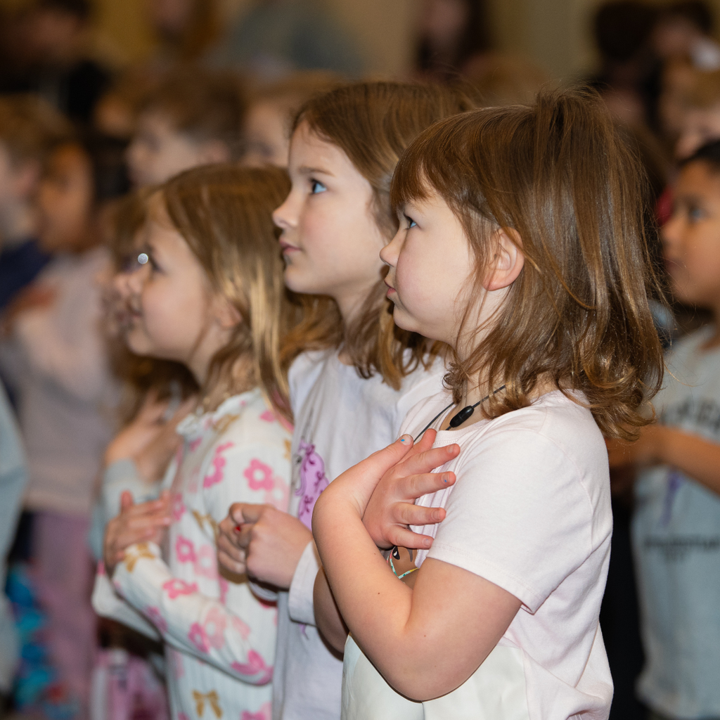 elementary students worshiping in chapel