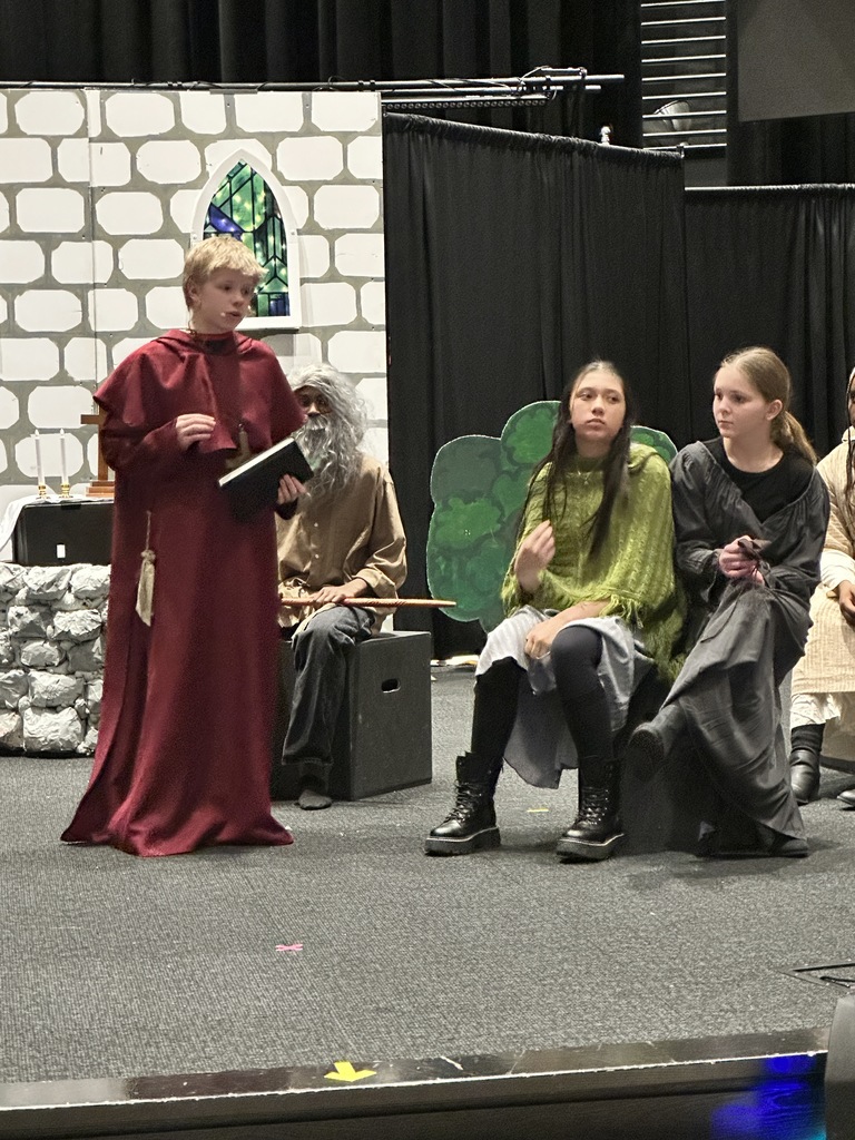 students on stage rehearsing a play