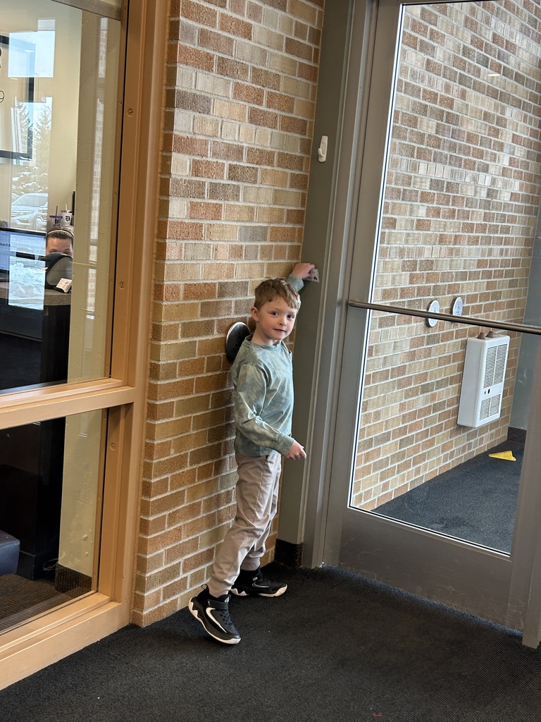 a student finding a clue on a scavenger hunt