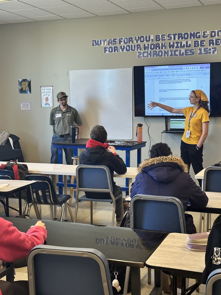science teacher in the front of the classroom introducing her guest speaker