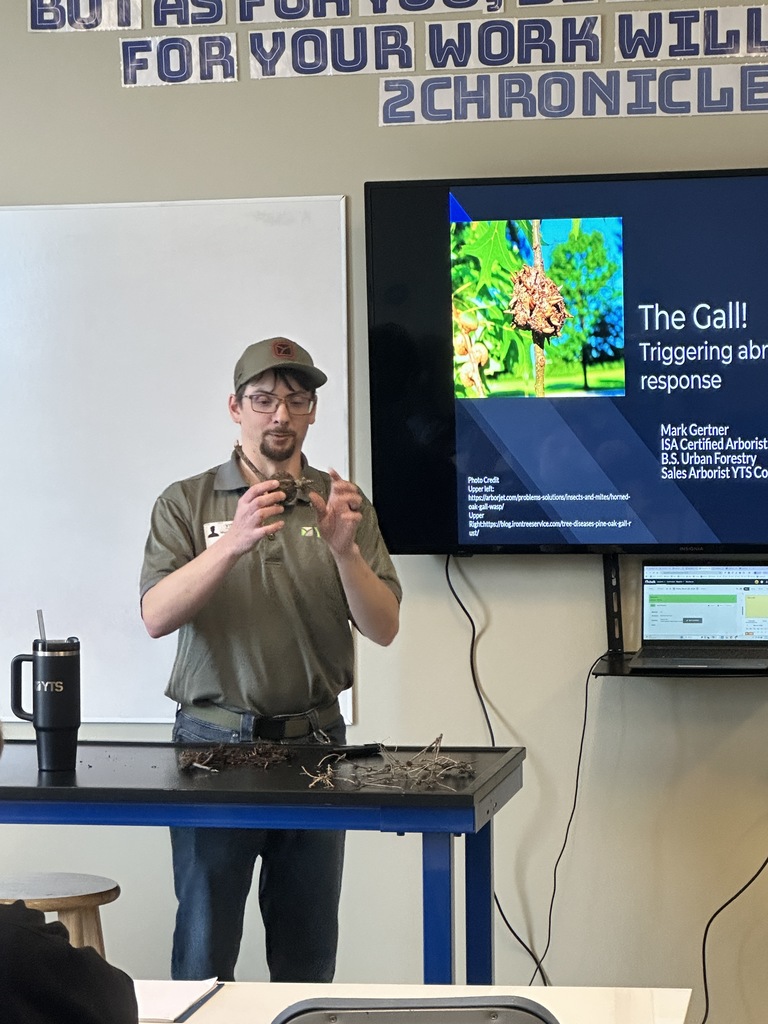 arborist speaking in the front of a classroom