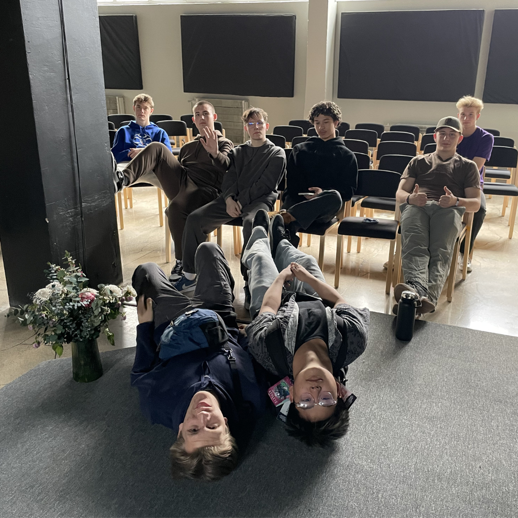 six high school boys sitting in chairs and two on the floor