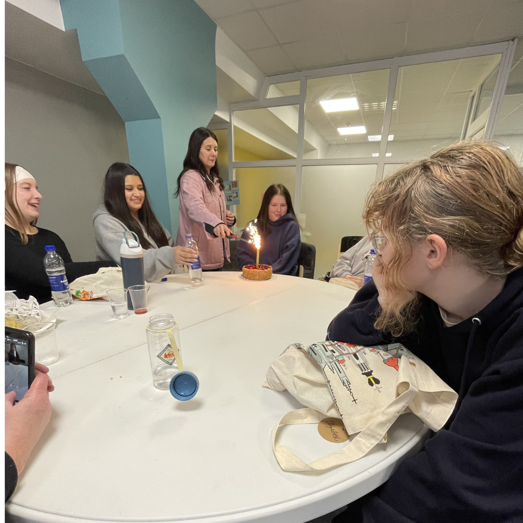 student being given a birthday dessert
